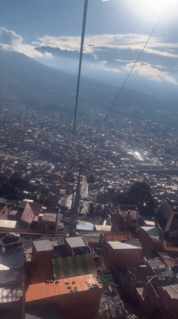Cable car rider films La Paz cityscape from above