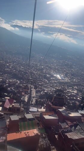 Cable car rider films La Paz cityscape from above