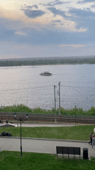 Sunset observed over Kama River in Perm with boat traffic