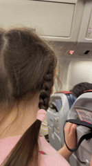 Flight attendant demonstrates safety procedures aboard aircraft near Yekaterinburg