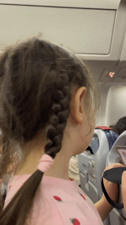 Flight attendant demonstrates safety procedures aboard aircraft near Yekaterinburg