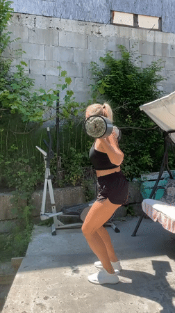 Woman performs outdoor fitness routine in Baranovka, Russia