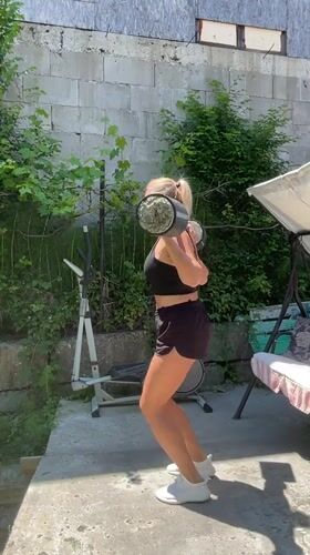 Woman performs outdoor fitness routine in Baranovka, Russia