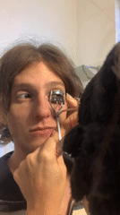 Person applies eyelash curler in Buenos Aires bathroom