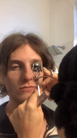 Person applies eyelash curler in Buenos Aires bathroom