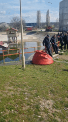 Firefighters and uniformed personnel work on equipment in Montana, Bulgaria