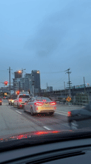 Vehicle travels New Westminster street under overcast afternoon sky