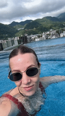 Late-night infinity pool selfies capture Beppu city views