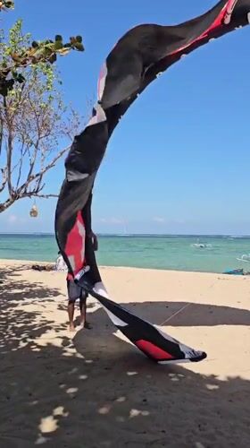 Kiteboarding action on a sunny Denpasar beach
