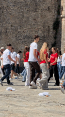 Young adults perform coordinated dance in Budva plaza
