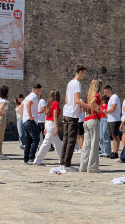Young adults perform coordinated dance in Budva plaza