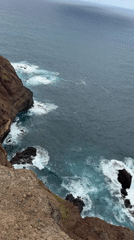 Tourists document dramatic coastal scenery at Machico clifftops