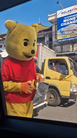 Person in Winnie the Pooh costume spotted on Kuta street