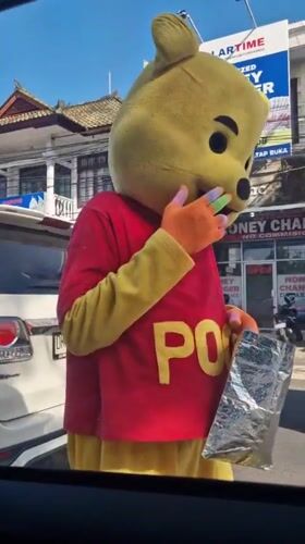 Person in Winnie the Pooh costume spotted on Kuta street