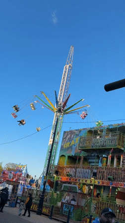 Fairground swing ride operates in Great Yarmouth on sunny day