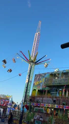 Fairground swing ride operates in Great Yarmouth on sunny day