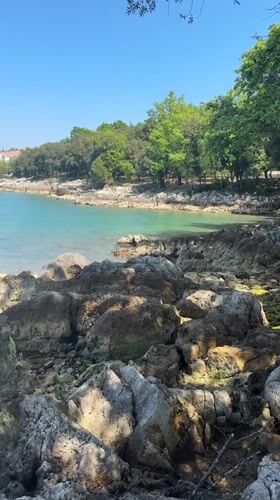 Sunny coastal scenes documented along rocky Vrsar shoreline