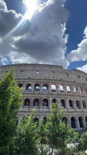 Tourist captures multiple angles of Colosseum on sunny morning