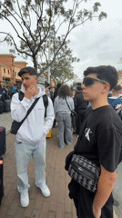 Young travelers with luggage wait for transport in Punta Umbría
