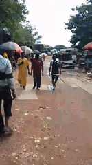 Street market activity and welding work in Abuja