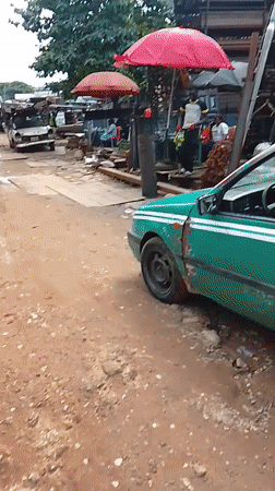 Street market activity and welding work in Abuja