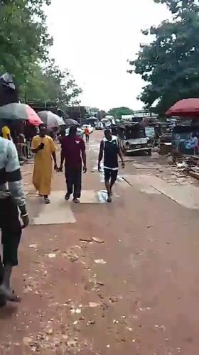 Street market activity and welding work in Abuja