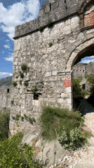 Tourists photograph themselves exploring ancient ruins in Montenegro mountains
