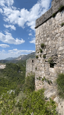Tourists photograph themselves exploring ancient ruins in Montenegro mountains