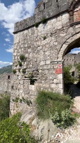 Tourists photograph themselves exploring ancient ruins in Montenegro mountains