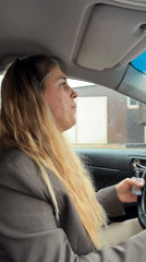 Two women sing along to music while driving in Chaikovsky