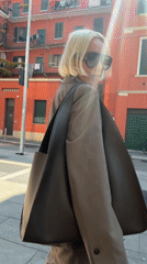Woman in brown suit spotted outside red building in Milan