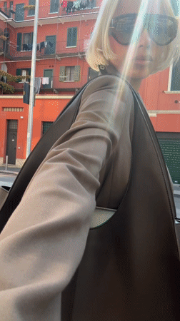 Woman in brown suit spotted outside red building in Milan