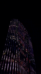 Colorful light display illuminates tall building in Nha Trang