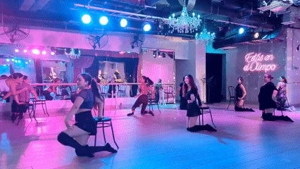 Chair-based dance class in a neon-lit Santiago studio