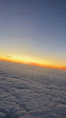 Passenger records sunset view from airplane over Buenos Aires