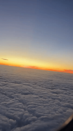 Passenger records sunset view from airplane over Buenos Aires