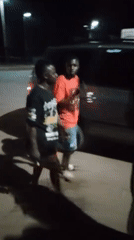 Nighttime street activity near a busy urban transit area