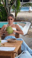 Woman in casual attire sits at table in Nusa Penida
