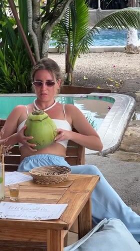 Woman in casual attire sits at table in Nusa Penida