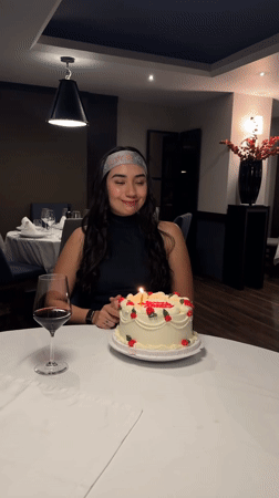 Woman celebrates birthday with cake at Puebla restaurant