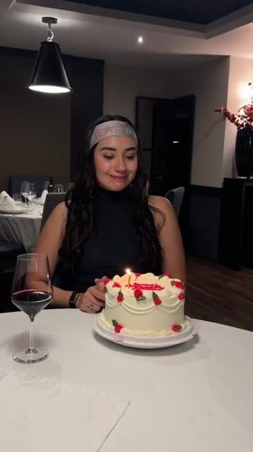 Woman celebrates birthday with cake at Puebla restaurant