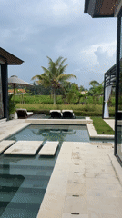 Woman enjoys luxury resort morning in Ubud, Indonesia