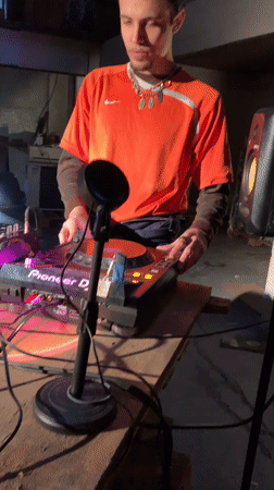 DJ performs in Buenos Aires warehouse space, filmed by witness