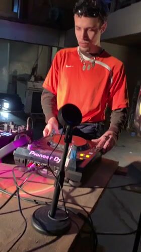 DJ performs in Buenos Aires warehouse space, filmed by witness