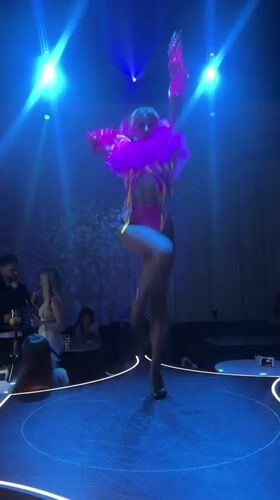 Pink-clad performer and DJ hold down a Moscow club night