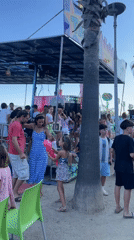Beachside fair day: rides, carnival games, and outdoor karaoke