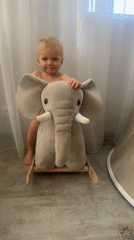 Toddler plays on elephant rocker in Russian home