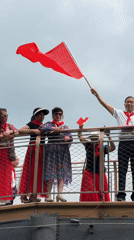 Group celebrates with Chinese flags on Chongqing bridge platform