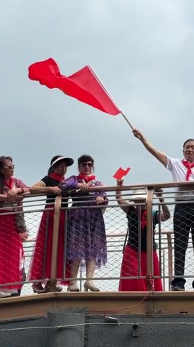Group celebrates with Chinese flags on Chongqing bridge platform