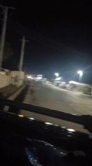 Evening street scene captured from moving vehicle in Wase